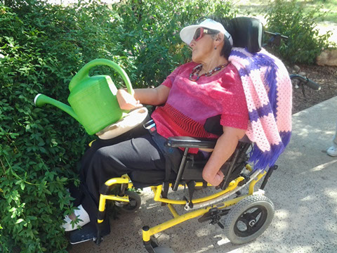 Groundskeeping training for an adult in a wheelchair